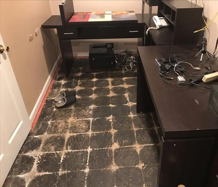 Desk on the floor with the carpet removed