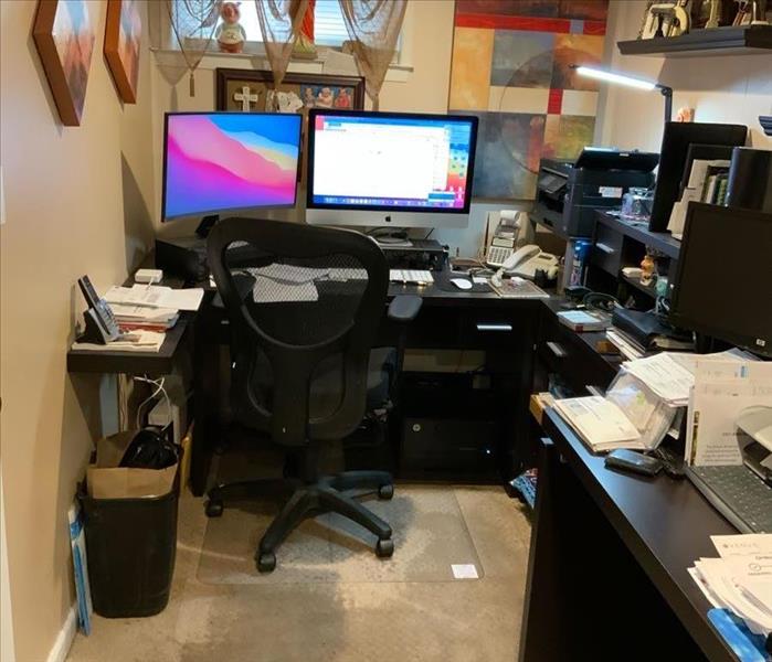 Basement office with computer equipment desks and chairs