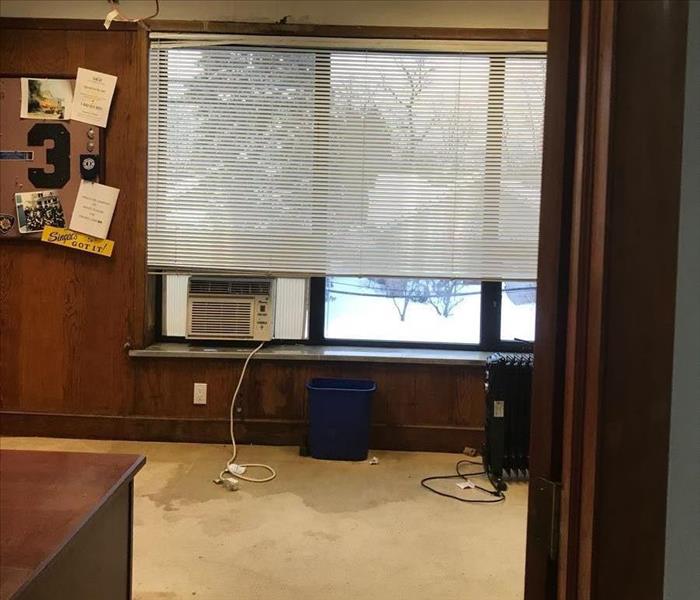Office with wet carpet and ceiling tiles