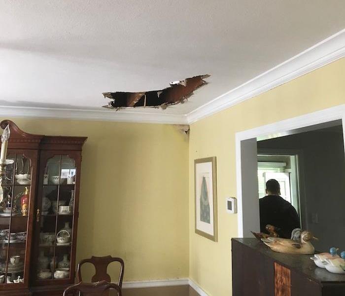 Dining room with a hole in a ceiling 