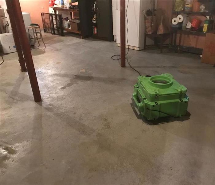 Basement with various items and SERVPRO equipment