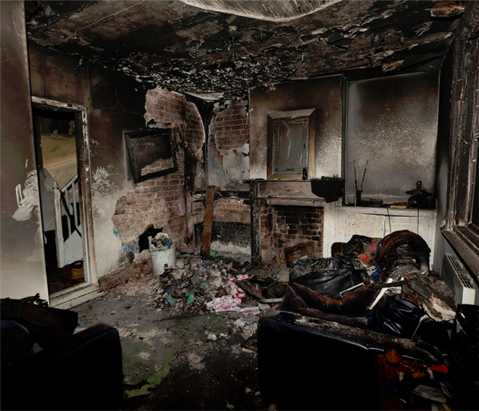 fire damaged living room with burned items everywhere
